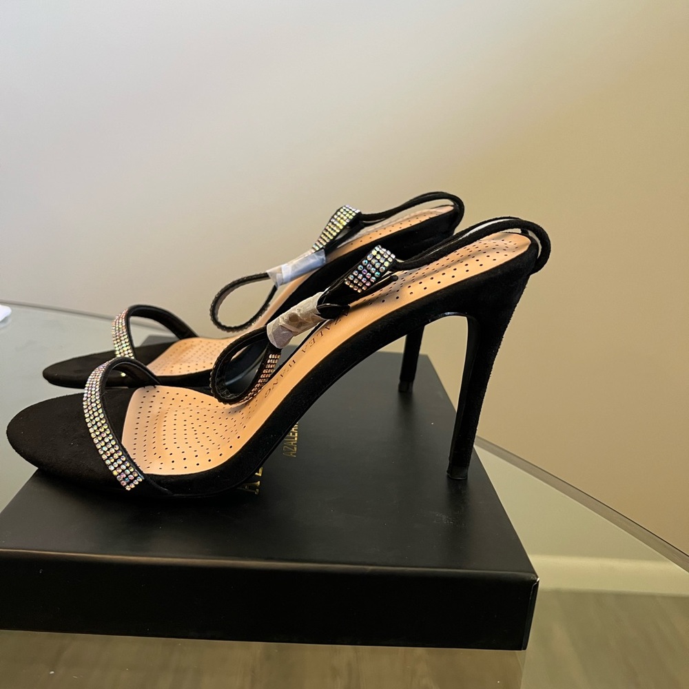 Lansing black with iridescent stones. Buckles around ankle strap